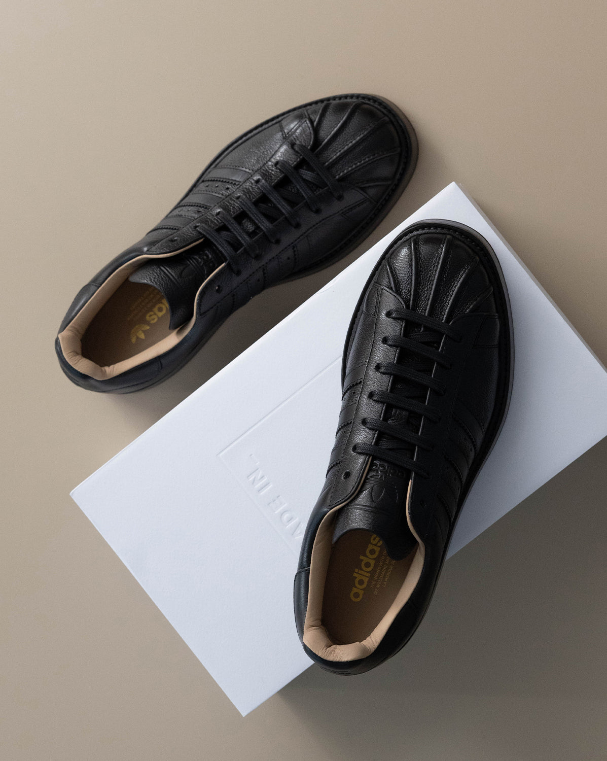 black leather adidas superstars